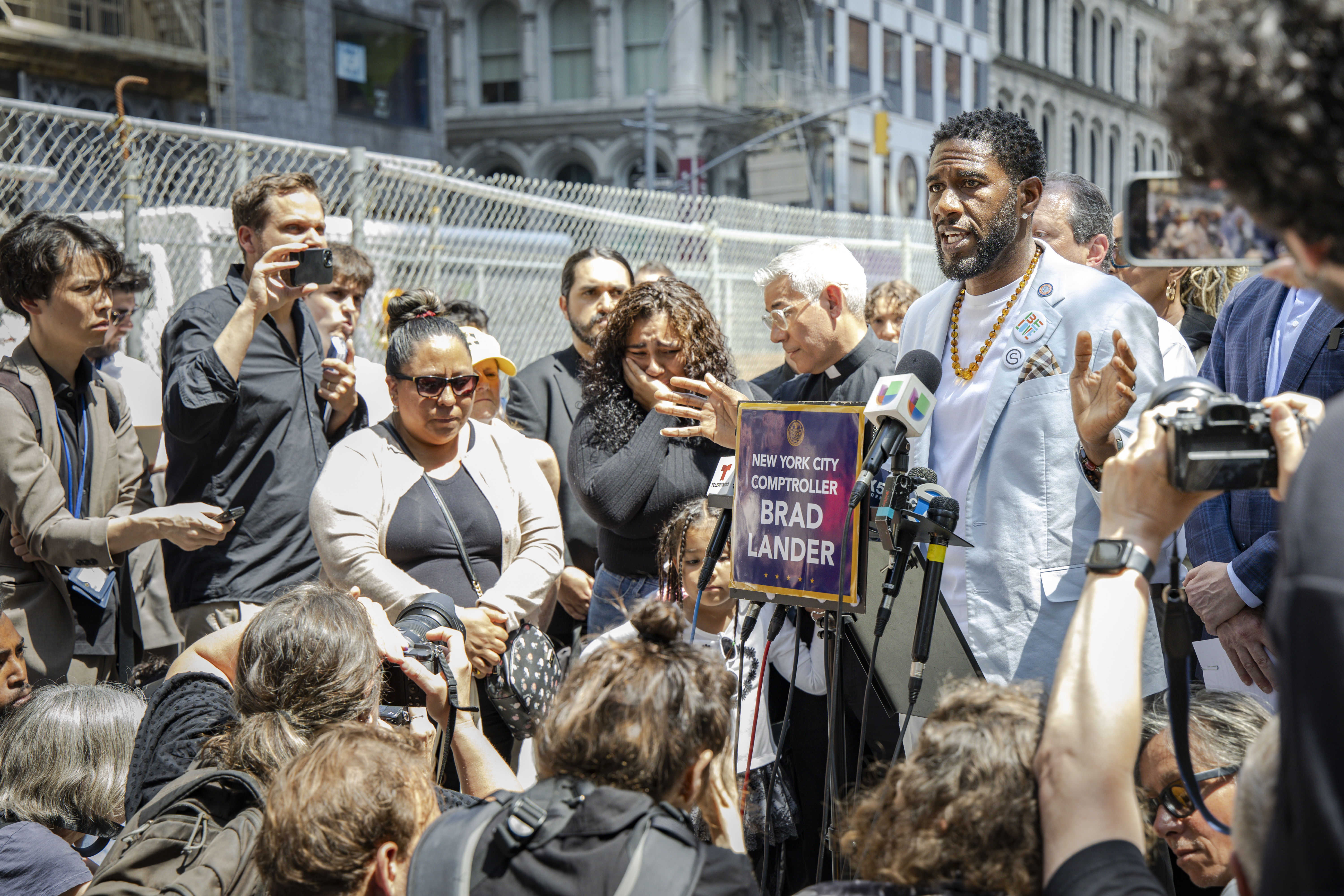 The Public Advocate speaks at a press conference near 26 Federal Plaza, surrounded by elected officials, faith leaders, and two family members of a detained New Yorker