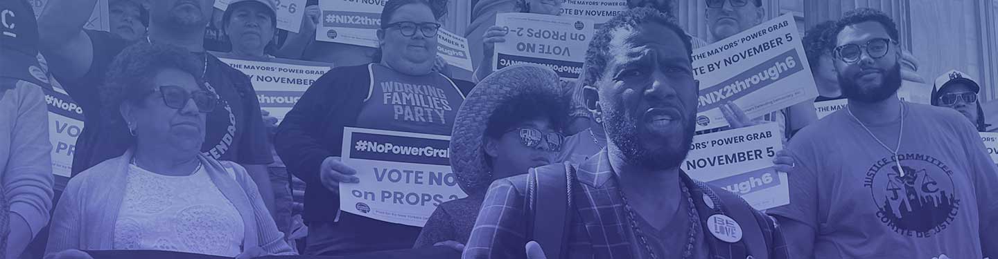 The Public Advocate speaks outside Tweed Courthouse into a microphone stand as a crowd behind him holds posters and banners reading, #NoPowerGrabNYC. Vote NO on Proposals 2 - 6