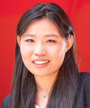 It's a headshot of Shuhan Wang, an Asian female with black hair and wearing a suit. Shuhan is smiling directly at the camera.