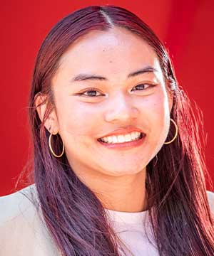 Headshot of Jessica Tang, an Asian woman with short red hair. Jessica smiles directly at the camera.