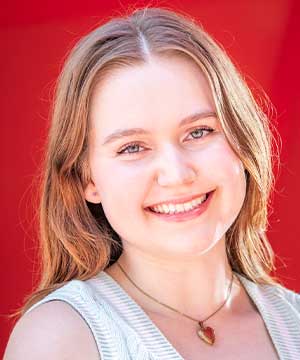 Headshot of Nicole Klokiw, a white woman with light brown hair wearing pastel green. She is smiling directly at the camera.