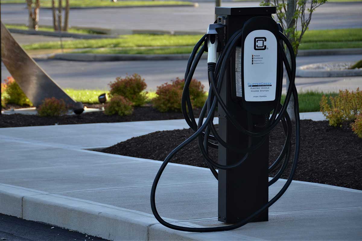 An electric vehicle charging station on a sidewalk